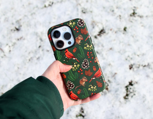 The winter hike-inspired phone case held above the snow.