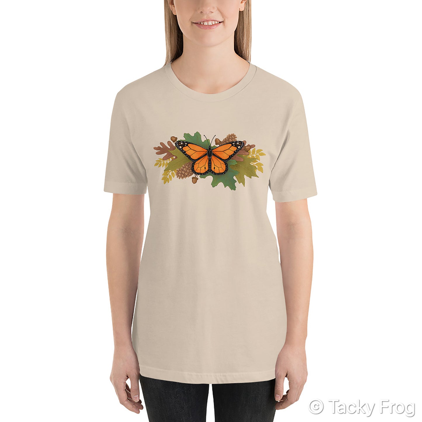 A mockup of a soft cream t-shirt with a butterfly and autumn leaves on it.
