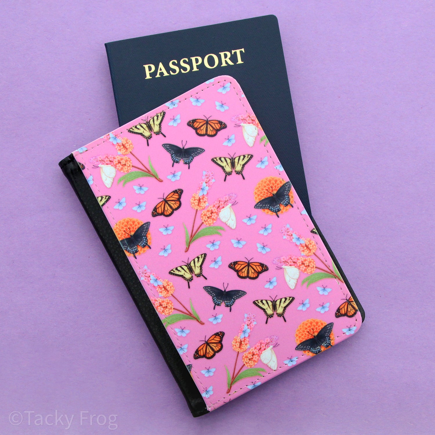 a pink passport wallet with butterflies and flowers on it.