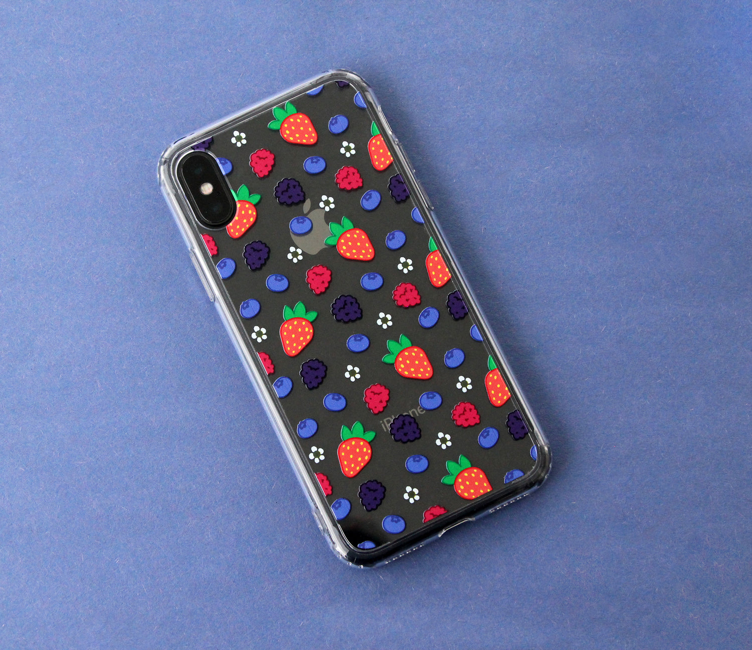 A slightly flawed transparent phone case featuring a mixed berry pattern. The flaw with this case is that the yellow centers of the daisies are transparent rather than opaque.