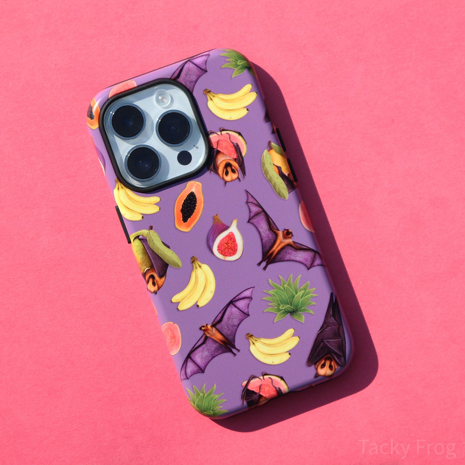 A purple phone case featuring a pattern of fruit bats and tropical fruits.