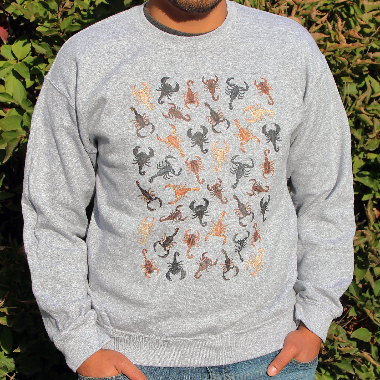 A man wearing a sweatshirt featuring a design of many scorpions.