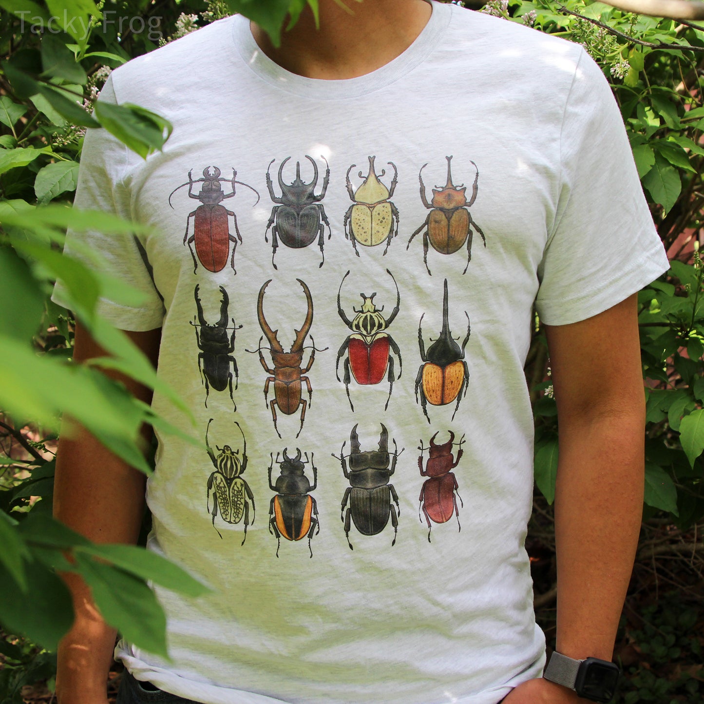 A man wearing the beetle unisex t-shirt in the color "ash". 