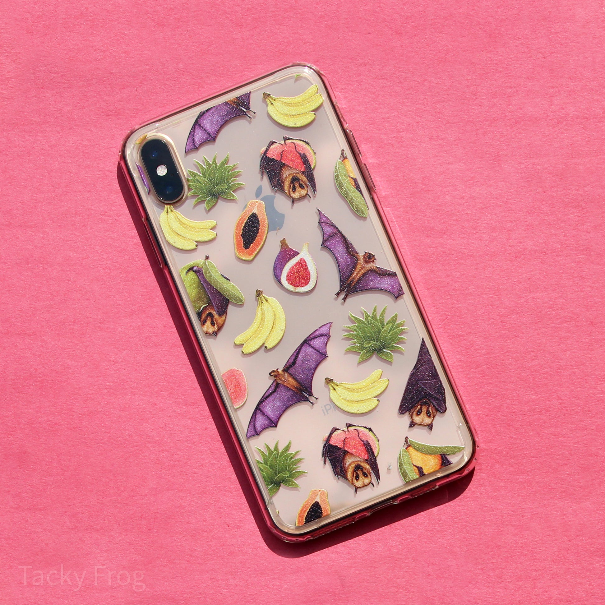 A clear phone case with various fruit bats and tropical fruit on it. The following fruit are depicted in the pattern: bananas, papayas, figs, and guavas. Agave plants are also included.