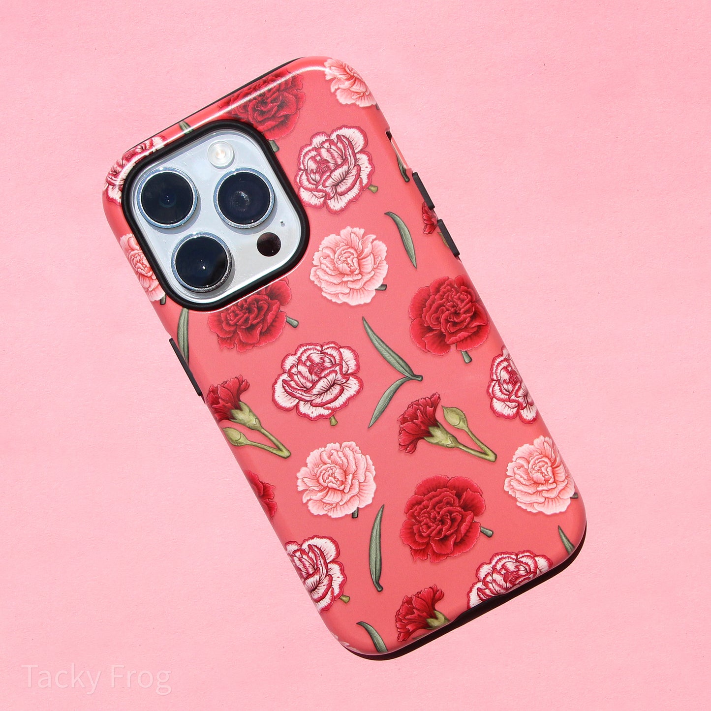 A dual-layered pink phone case featuring a pattern of red and pink carnations. The inner layer is solid black and is visible around the buttons, ports, and other openings.