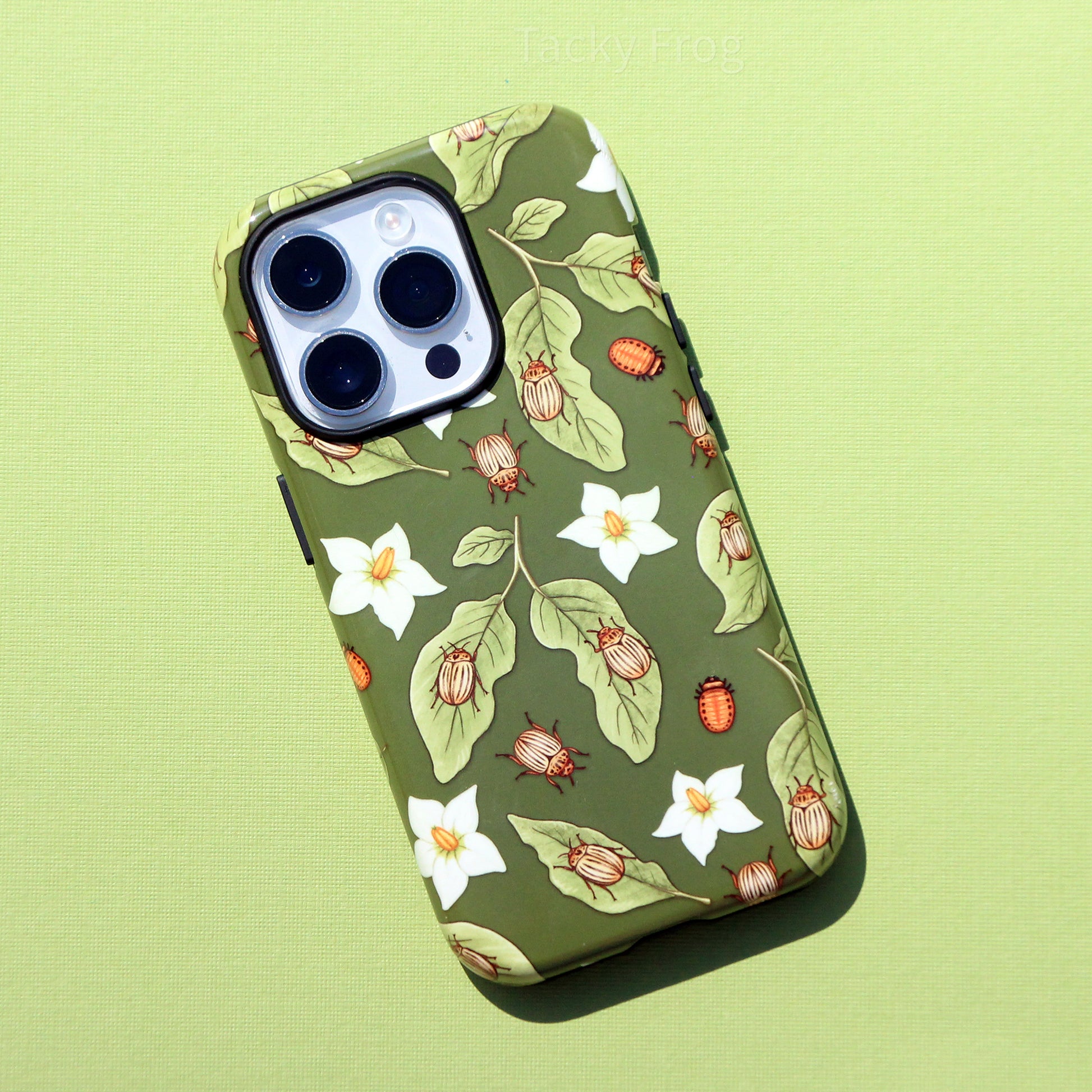 A full view of the potato beetle phone case against a green background.