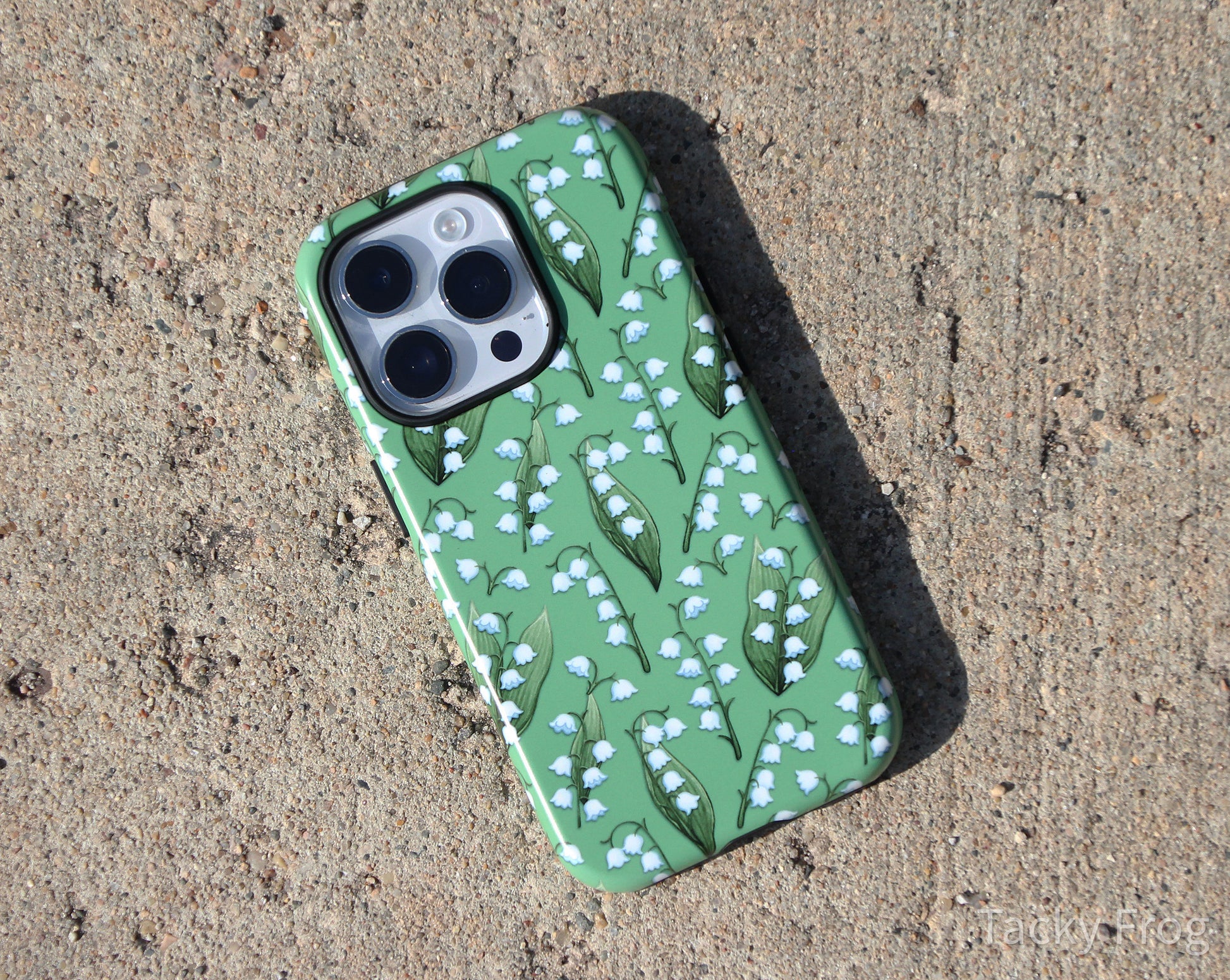 Another view of the lilies of the valley phone case. The inner layer of the case is solid black.