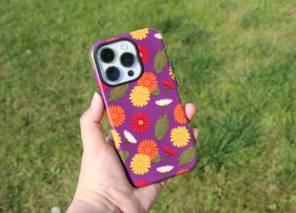 The Gerbera daisies case held over some grass.