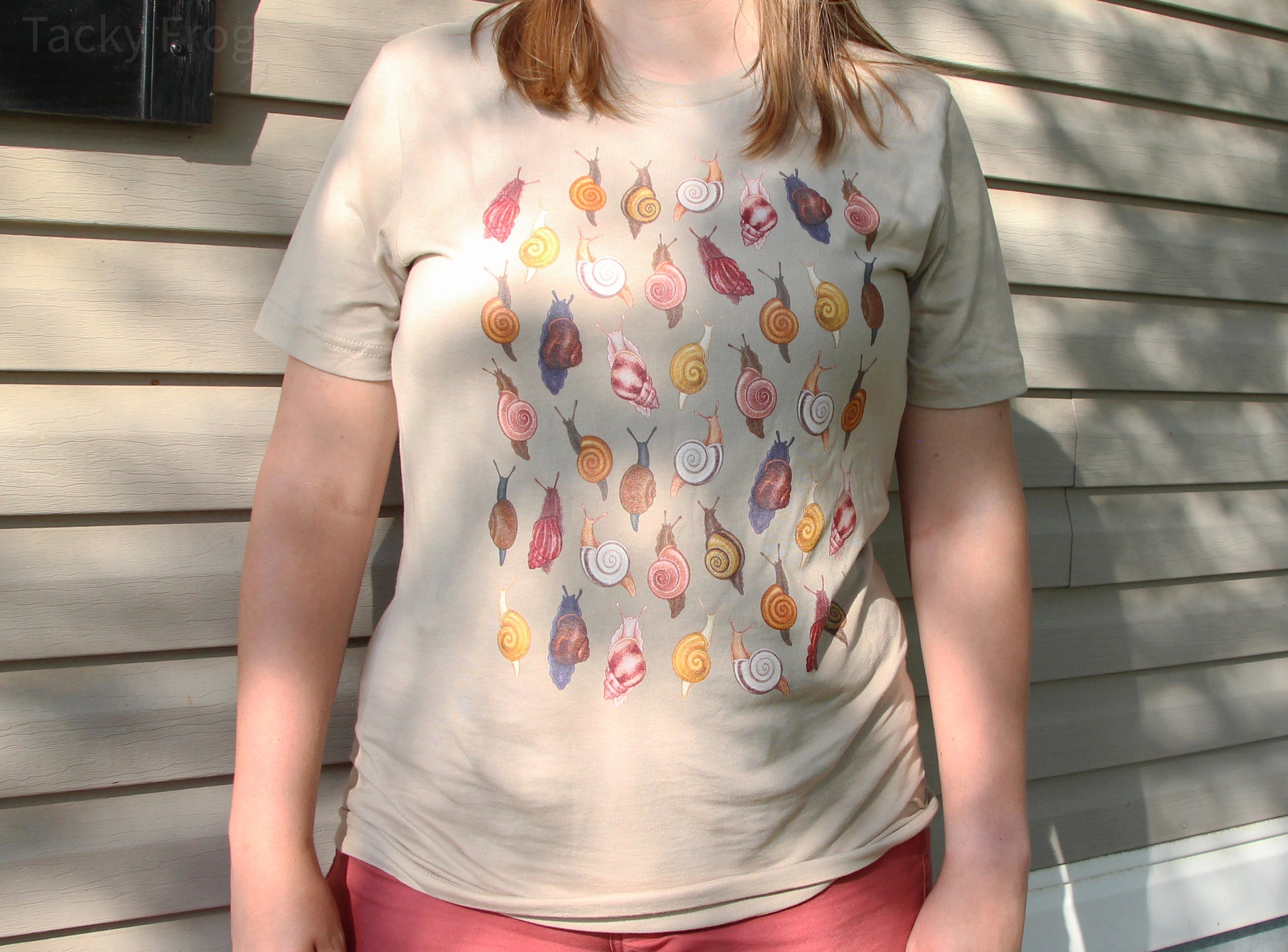 A full view of the tan-colored snail t-shirt.