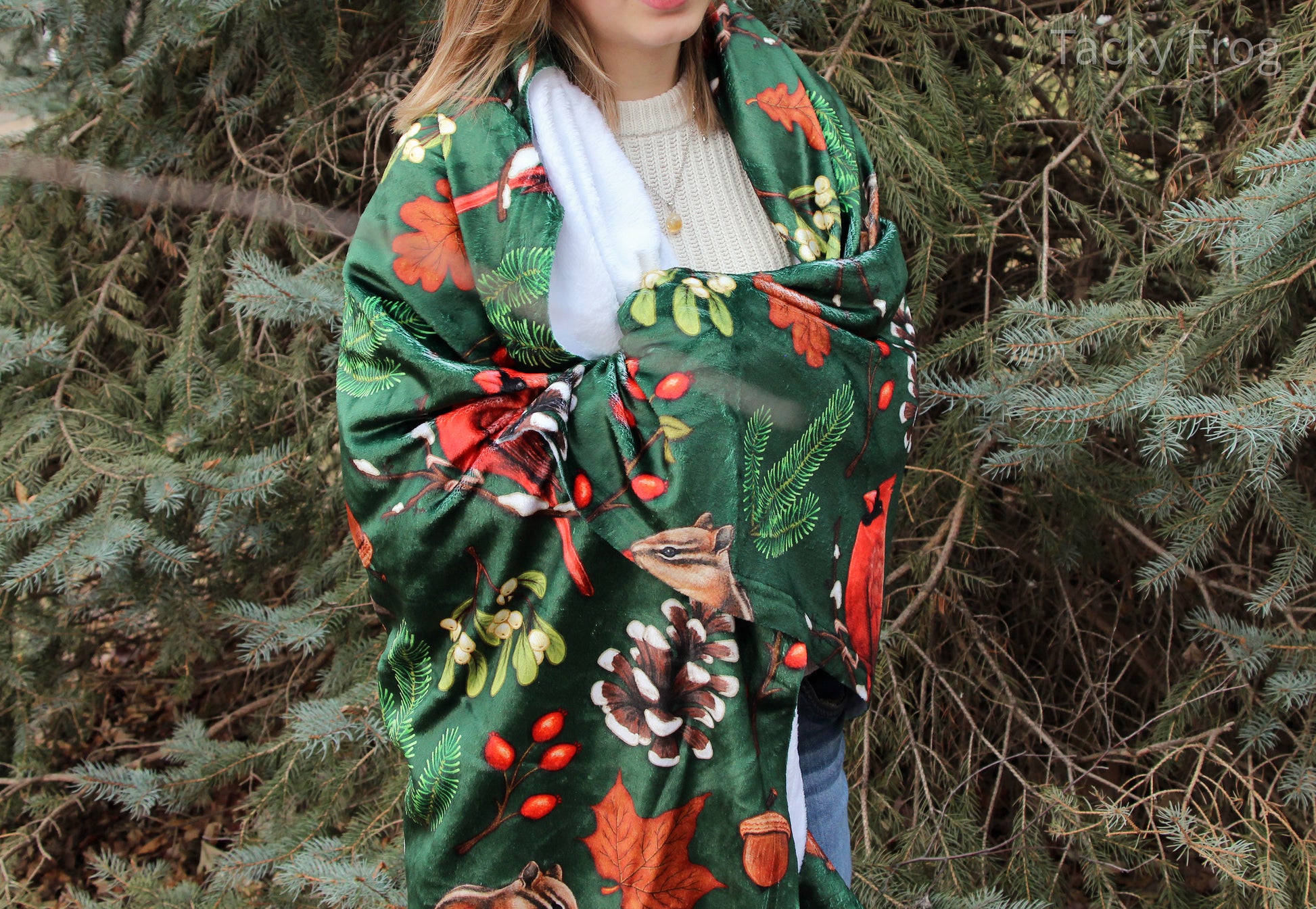 The winter foraging blanket wrapped around a young woman. The blanket is fairly thin and lightweight, making it easy to store.