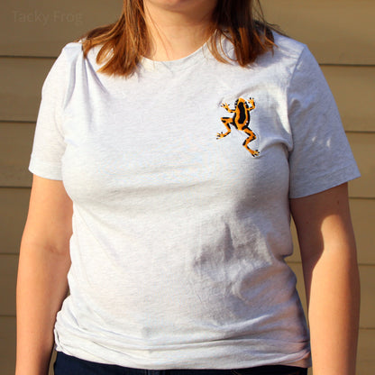 Another image of a woman wearing the yellow dart frog embroidered t-shirt. The photo was taken during sunset, so there is a slight warm glow in the photo.