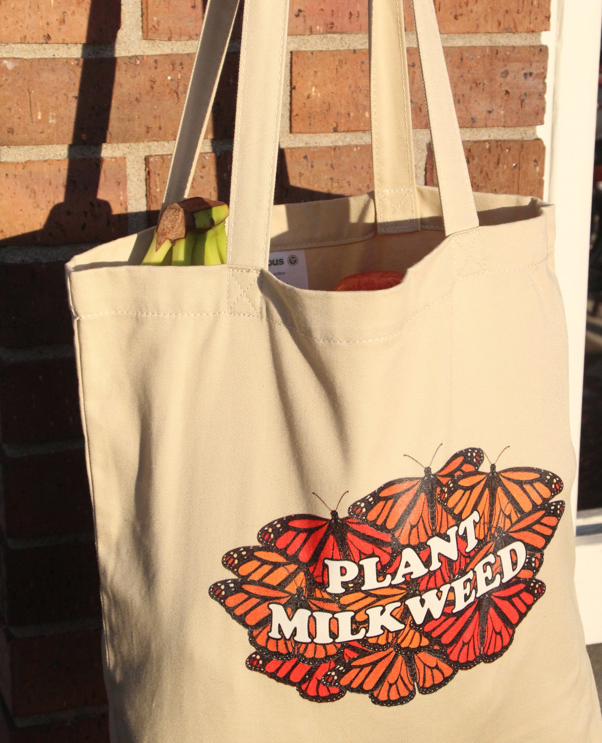 The plant milkweed tote bag. Some fruit is visible inside the bag.