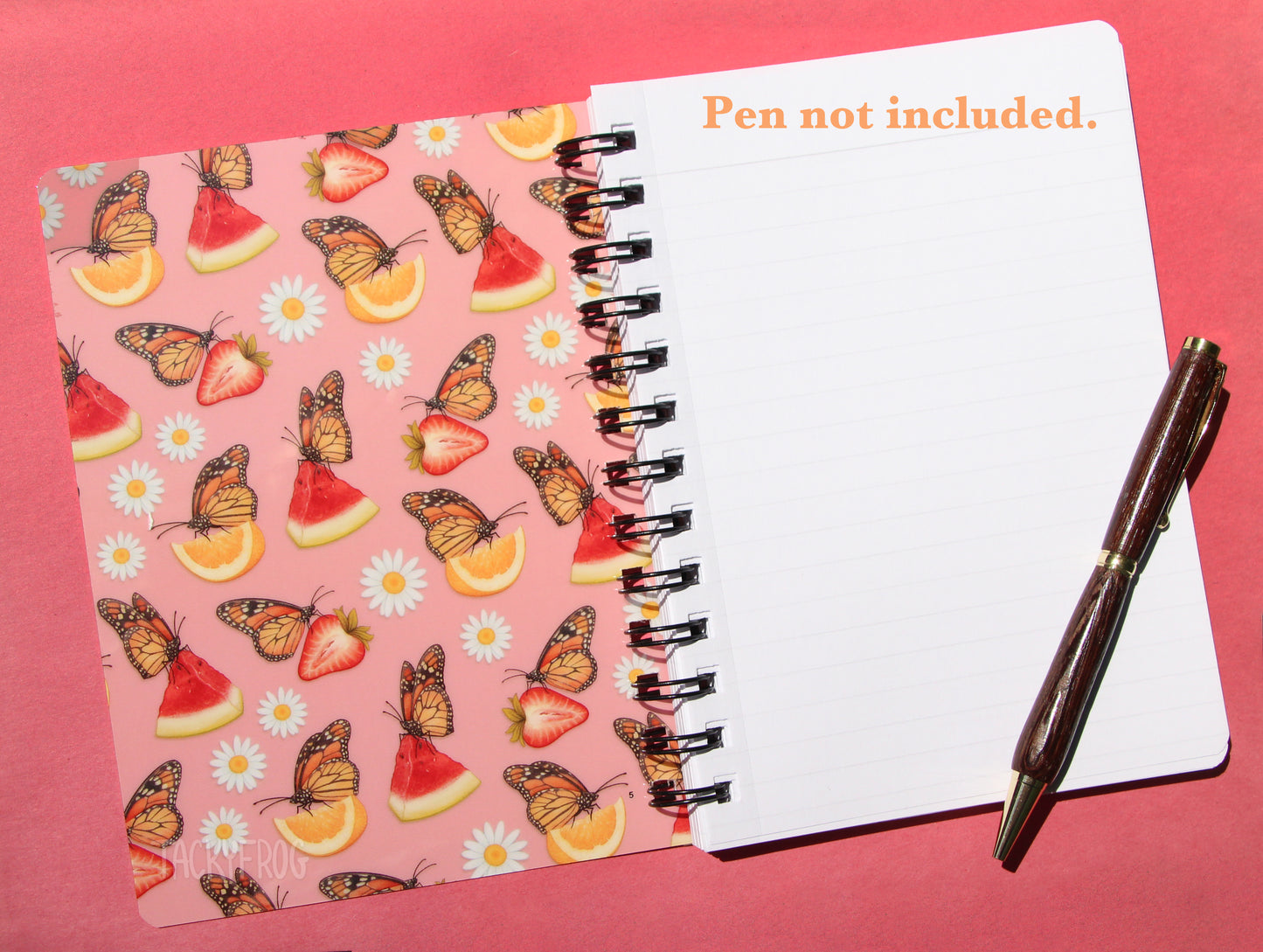 Inside the front cover of the notebook. Both sides of the front and back cover feature the pattern in full color. Pen not included.