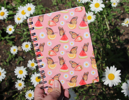 The hungry monarch butterfly pattern held over some daisies.