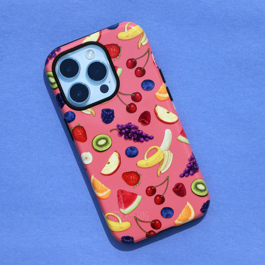 A pink phone case featuring a pattern of various fruits. The inner layer of the case, which is visible around buttons and openings, is solid black.