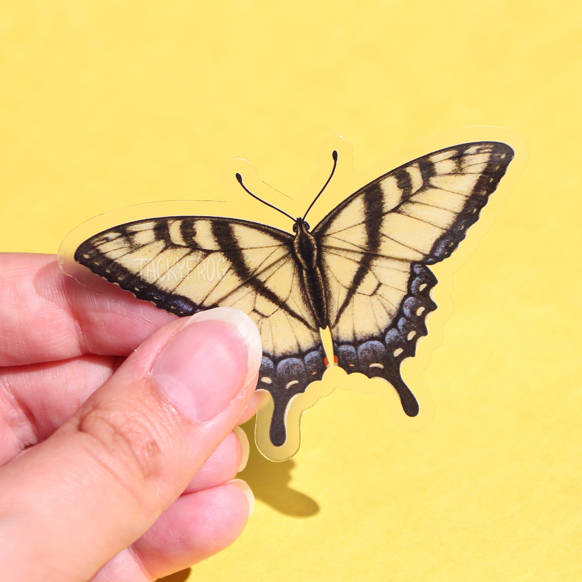 A clear sticker of a yellow swallowtail butterfly.