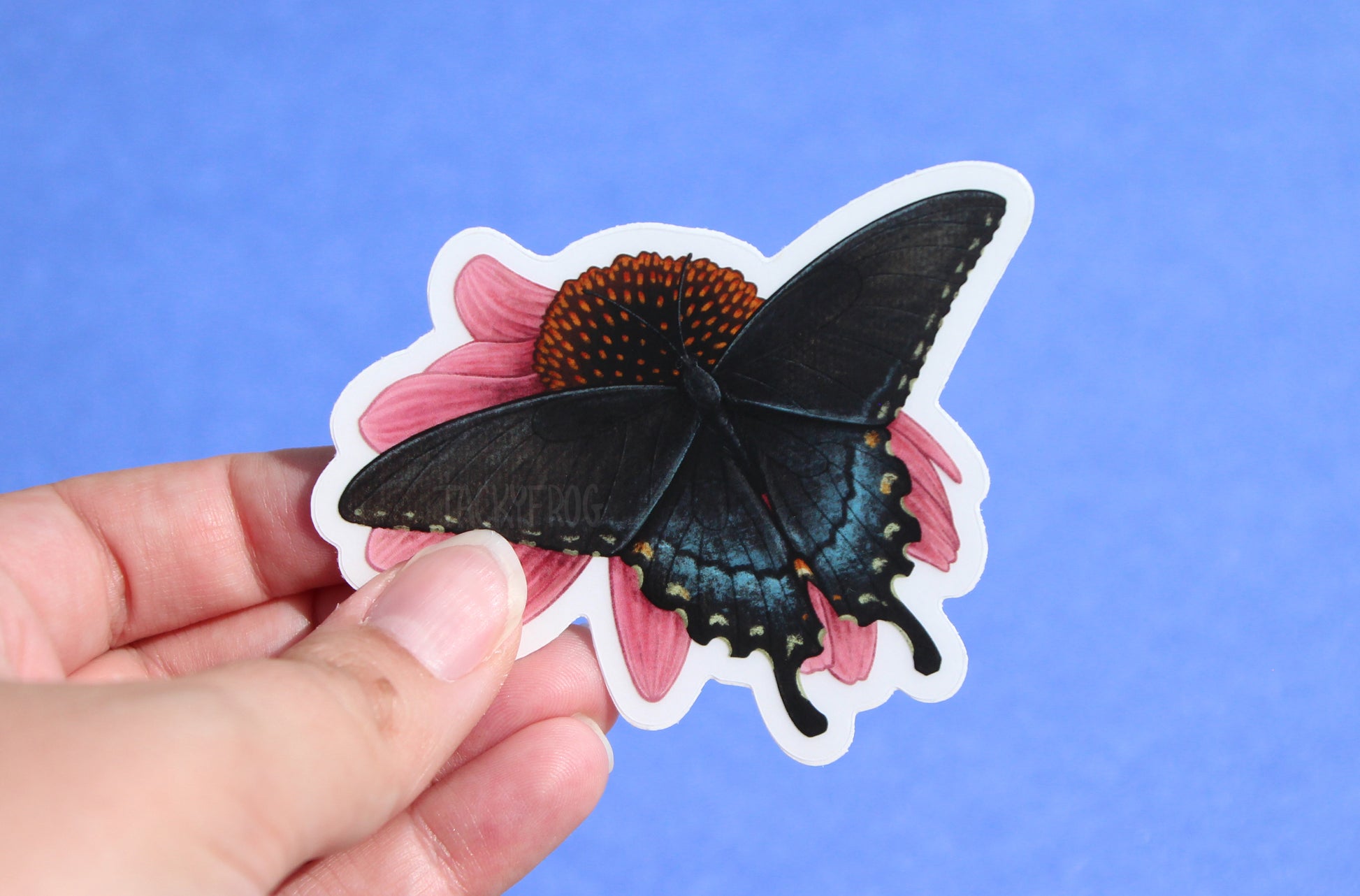 The swallowtail butterfly on coneflower sticker with the white paper backing still on.