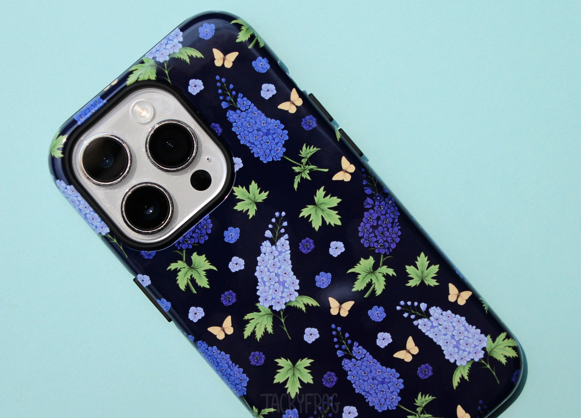 A closeup of the details on the larkspur phone case. The inner black layer of the case is visible around openings and buttons.