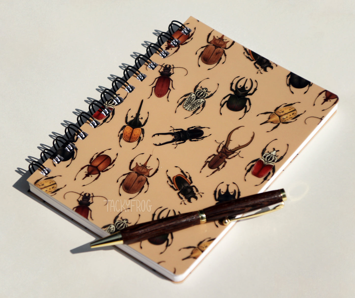 Another view of the beetle-patterned notebook. The pen is not included.