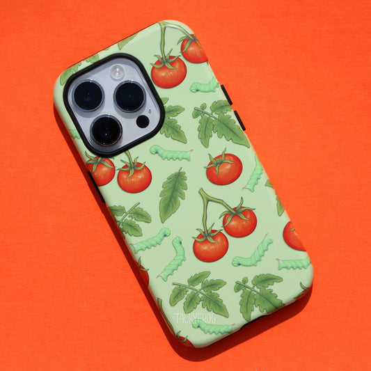 A light green tough phone case featuring a pattern of tomatoes, leaves, and caterpillars.