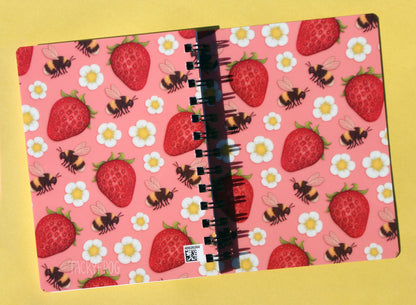 The back and front covers of the strawberries and bees-patterned notebook. Please note that there is a small QR code in the bottom right corner of the back cover for warehouse purposes.