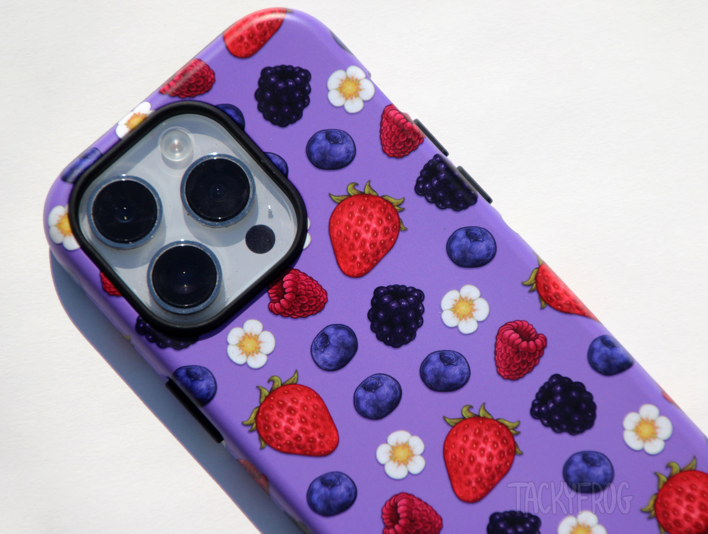 A close up of the details on the berry-patterned phone case.