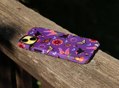 Another angle of the butterfly garden-inspired phone case. The inner layer of the case is solid black and is visible around openings and buttons.