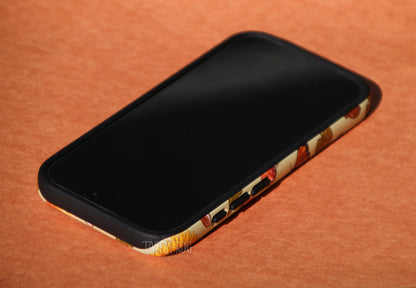 The early fall-inspired phone case shown screen side up. The inner layer of the case is solid black, and it's visible around buttons and openings.