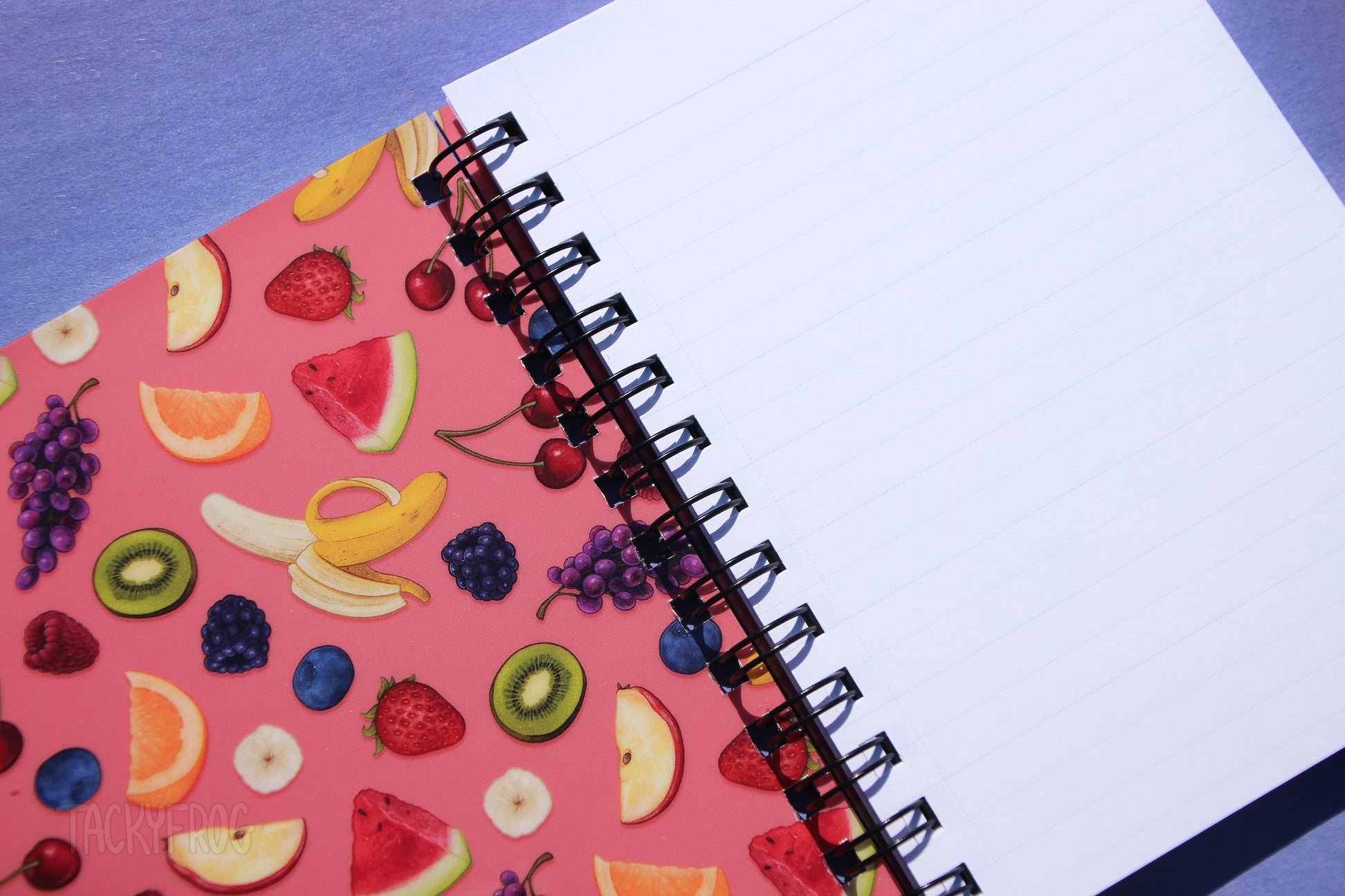 Both sides of the front and back cover feature the colorful fruit pattern. The pages are ruled line.
