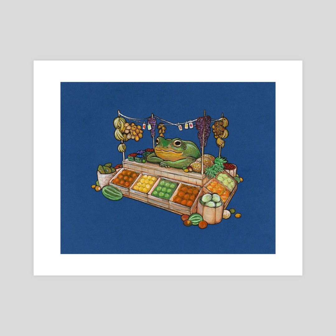 A mockup of an art print featuring a painting of a frog selling fruit at a market stand.