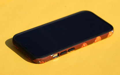 The ladybug phone case shown screen-side up.