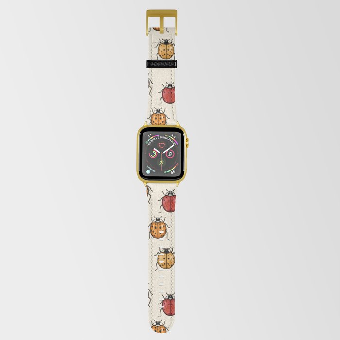 A cream-colored Apple Watch band with a ladybug design