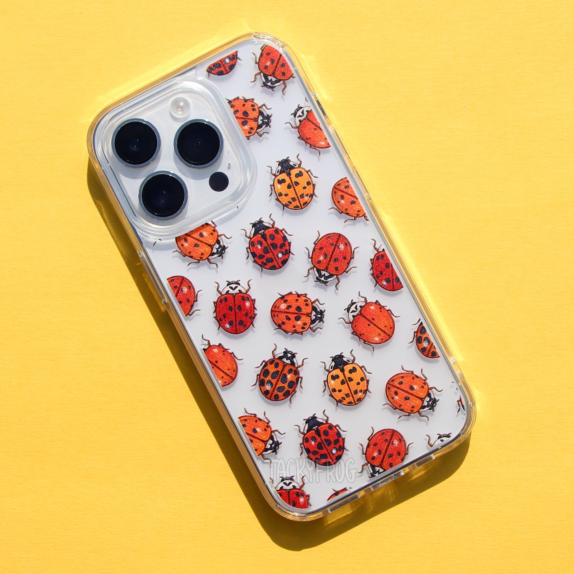 A clear phone case featuring a pattern of various ladybugs (or lady beetles).