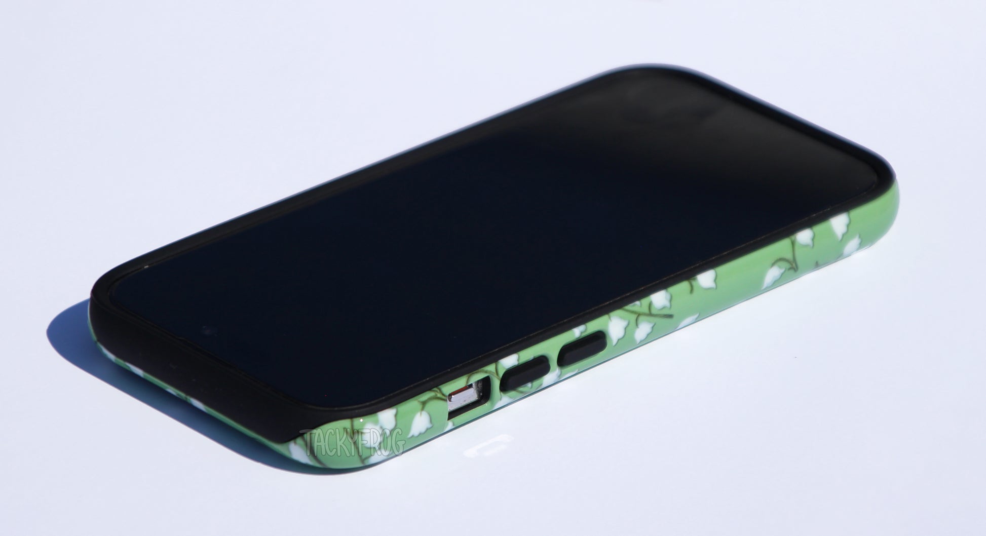 The lilies of the valley phone case shown screen-side up.