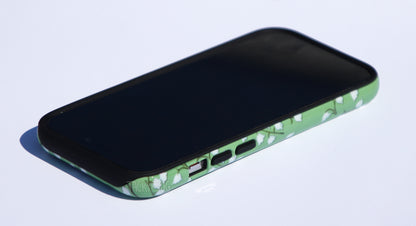 The lilies of the valley phone case shown screen-side up.