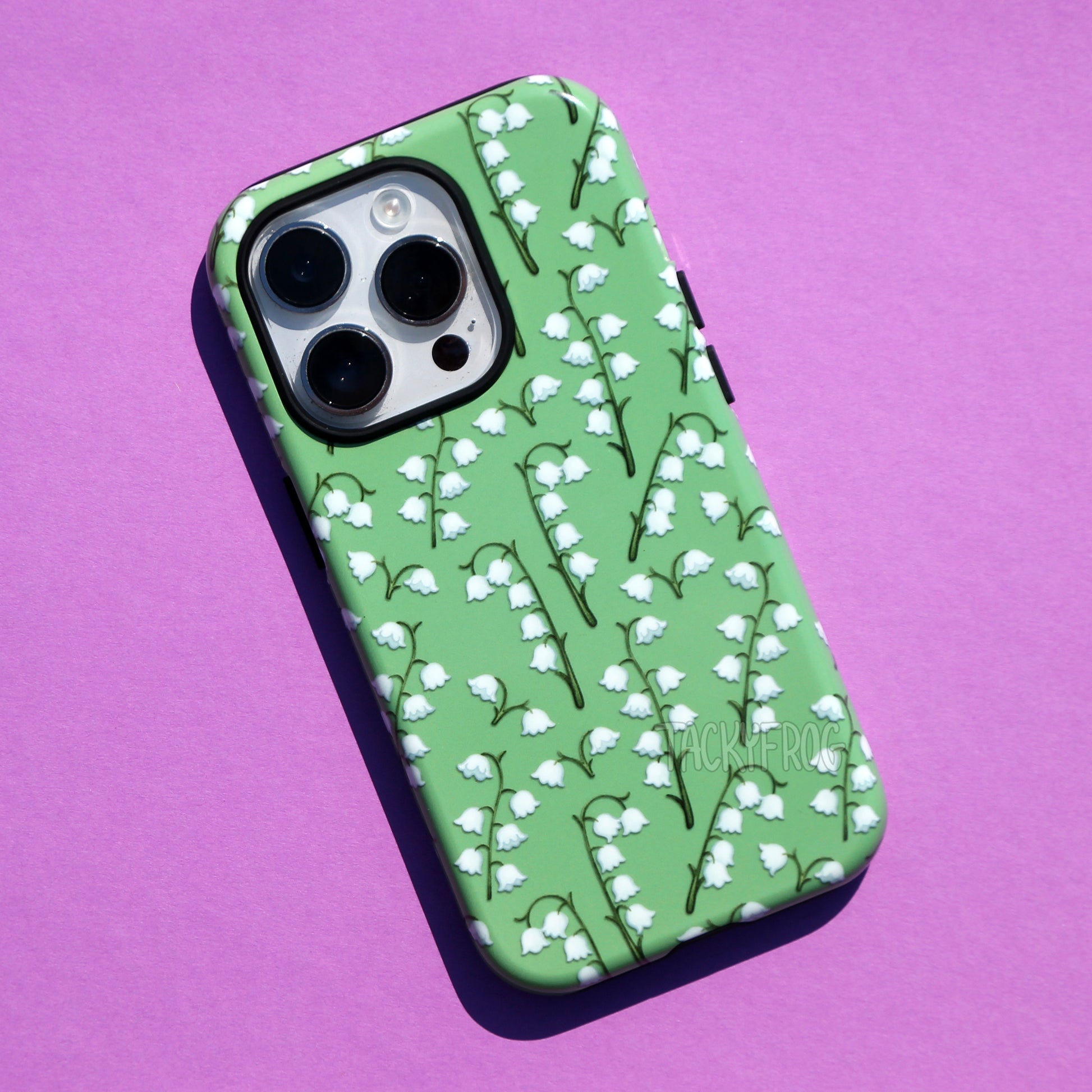 Another view of the lilies of the valley phone case. The inner layer of the case is solid black.