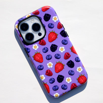 A purple phone case featuring a pattern of raspberries, strawberries, blackberries, blueberries, and white flowers.
