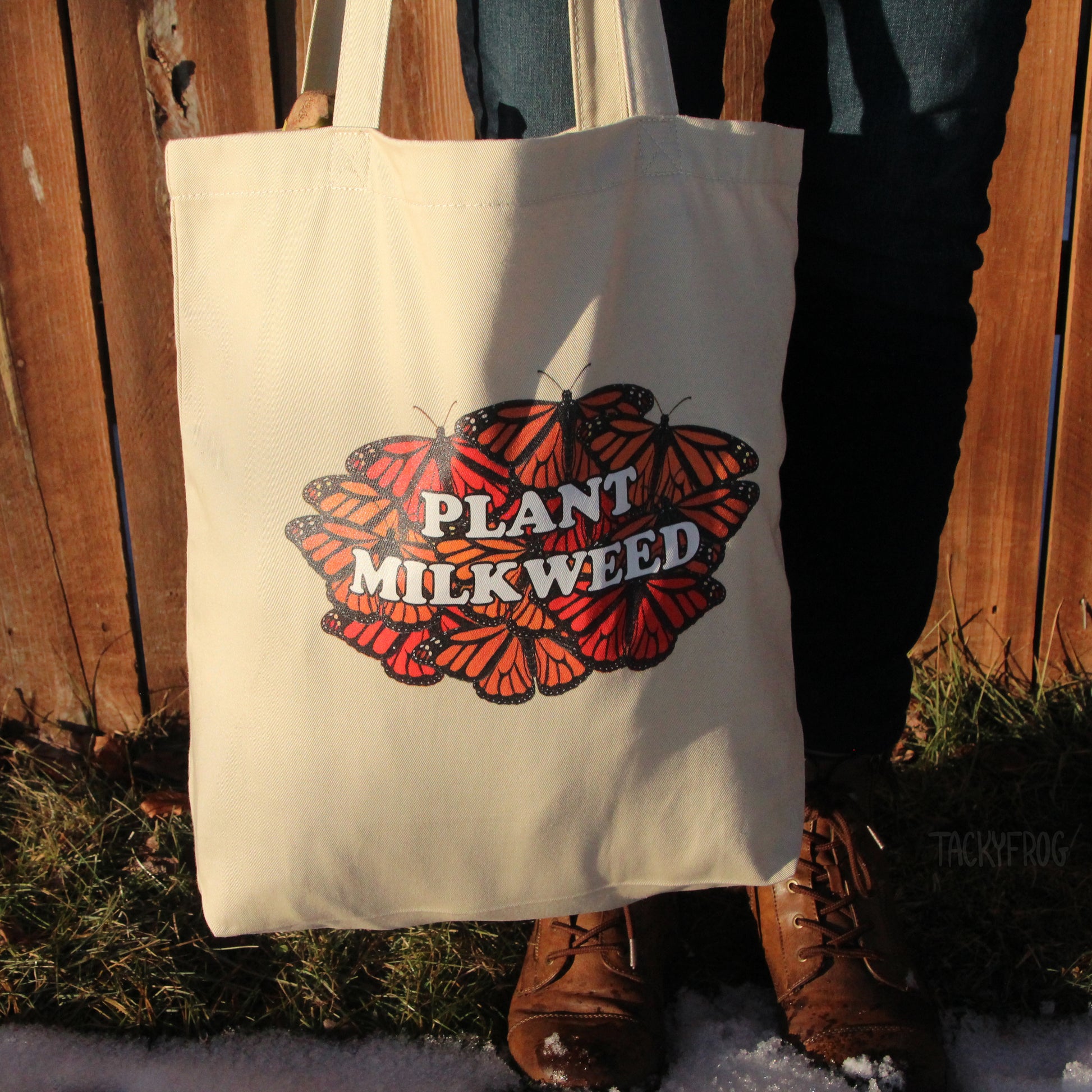 The "plant milkweed" tote bag carried outside.