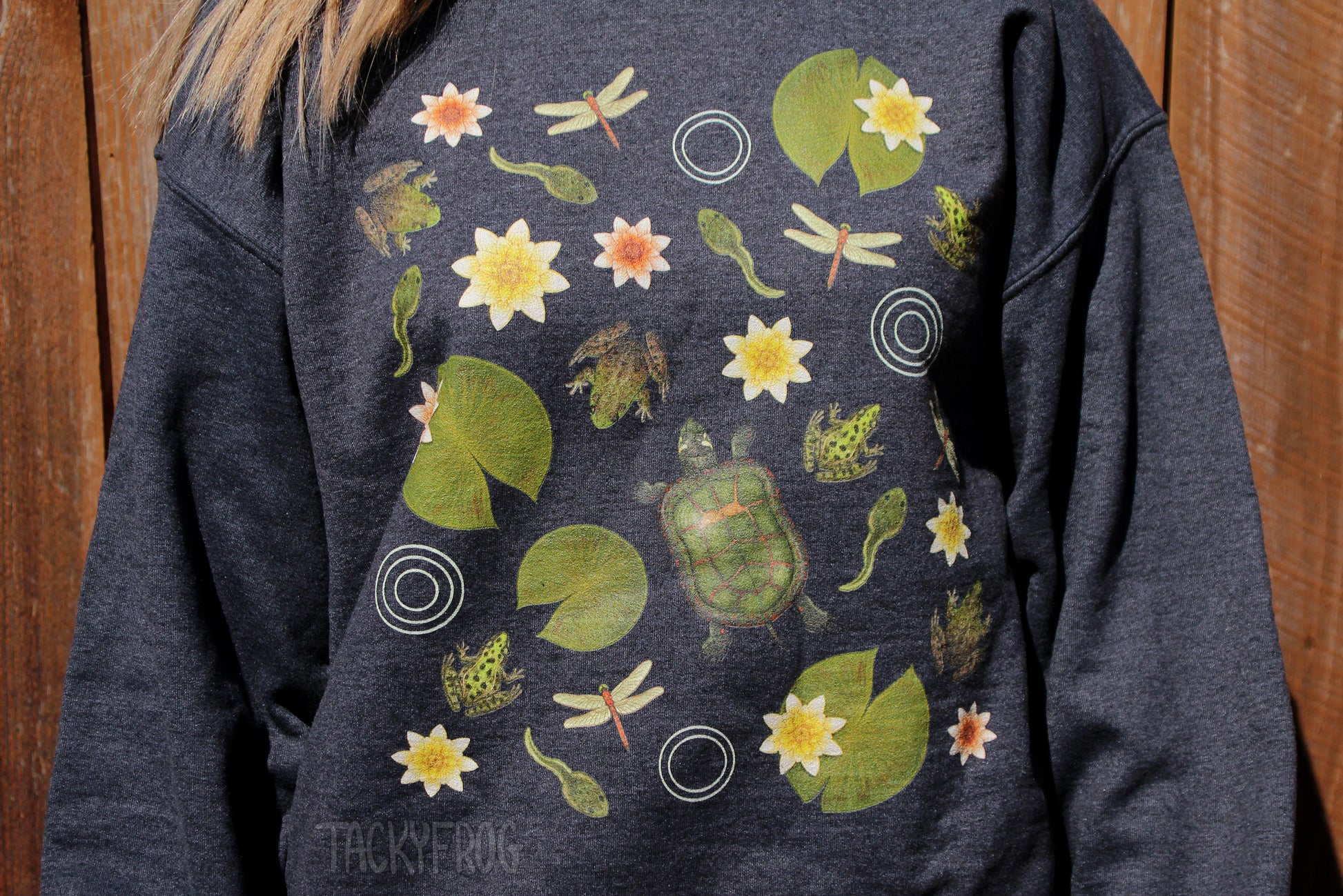 A closeup of the illustrations of insects, animals, and plants depicted on the sweatshirt. The sweatshirt color is "dark heather".