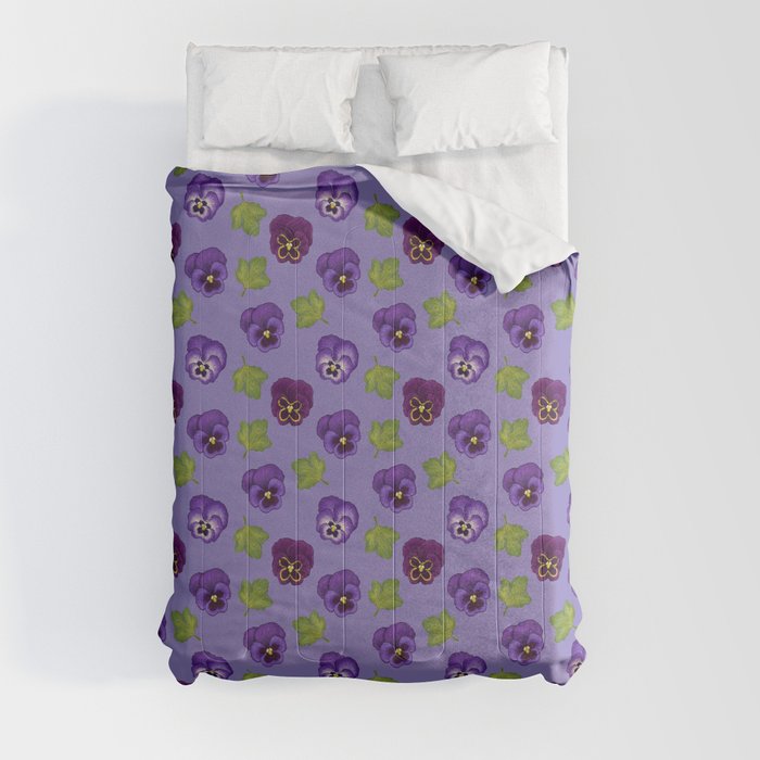 A purple comforter with a pansy flower pattern on it