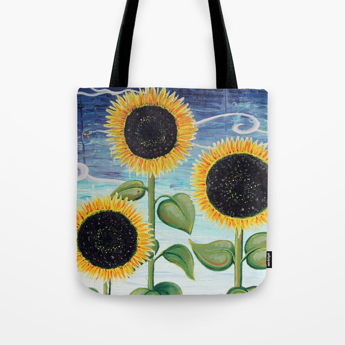 A tote bag with three sunflowers on it.