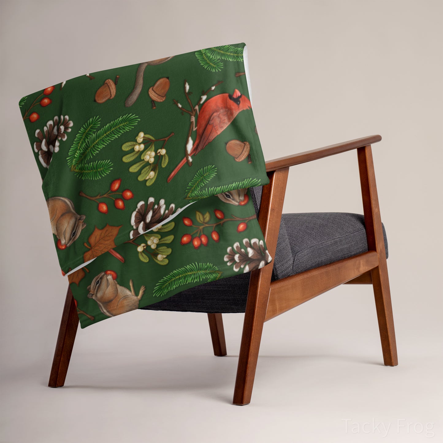 A mockup of the dark green winter foraging blanket draped over a chair.