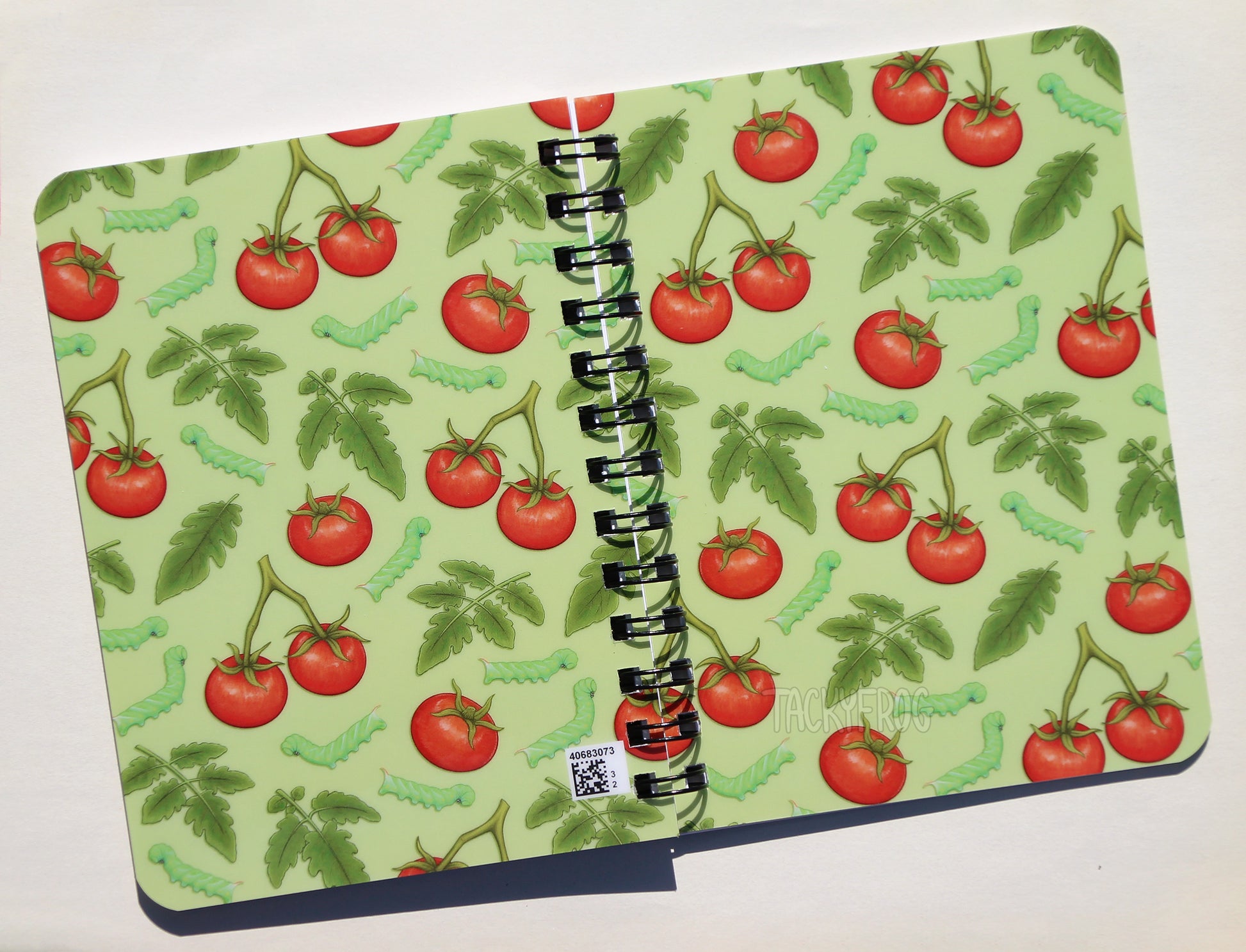 The front and back covers of the tomato hornworm caterpillar notebook. There is a small QR code in the bottom right corner of the back cover.