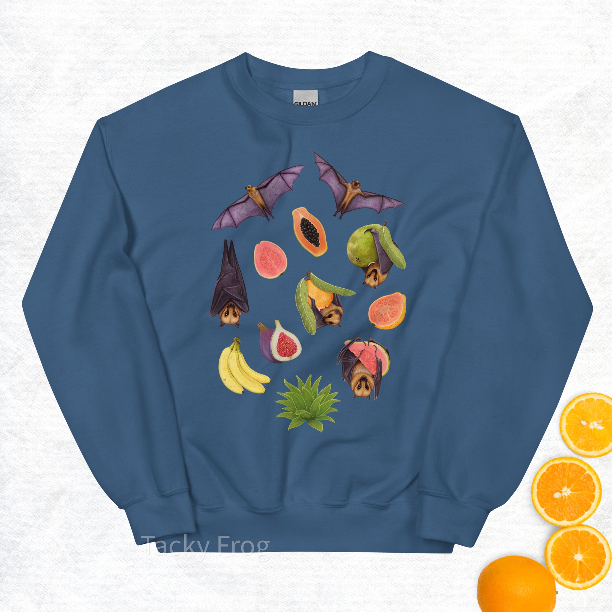 A mockup of the fruit bat sweatshirt in the color Indigo Blue. The mockup is surrounded by fruit.