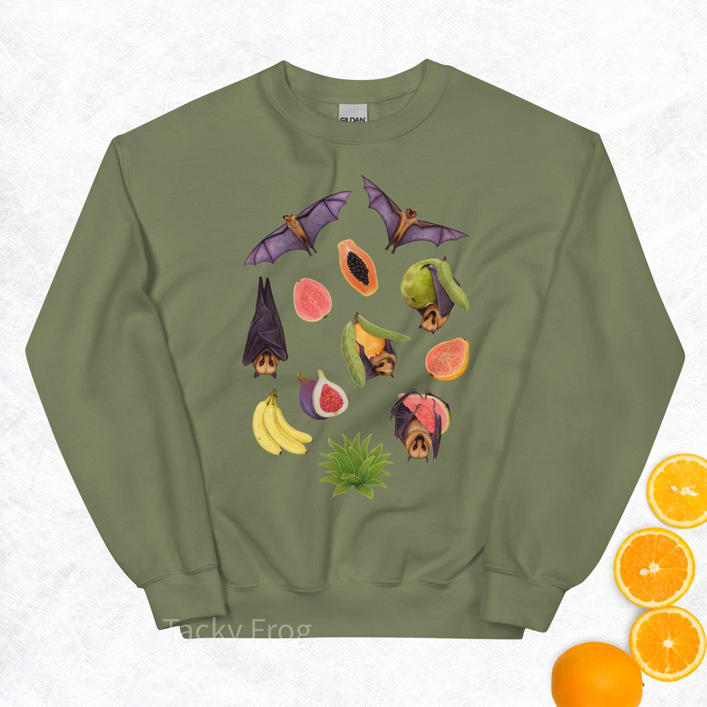 A mockup of the fruit bat sweatshirt in the color Military Green. The mockup is surrounded by fruit.