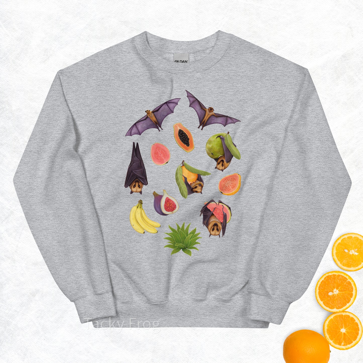 A mockup of the fruit bat sweatshirt in the color Sport Grey. The mockup is surrounded by fruit.