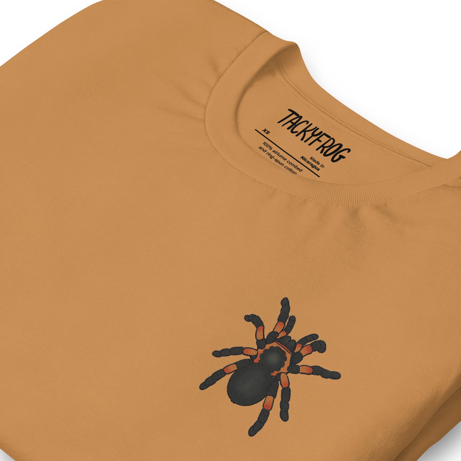 A mockup of the tarantula embroidered shirt in the color "toast".