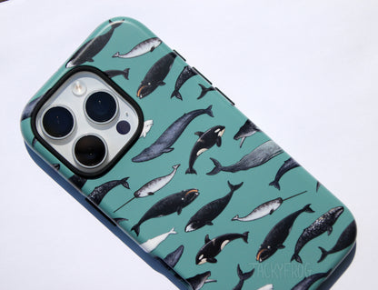 A close up of the whale phone case. There are nine species of whales depicted, including the humpback, orca, beluga, bowhead, and blue whale.