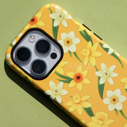 A close-up of the details on the yellow daffodils tough phone case. The black inner layer of the case is visible around buttons and openings.