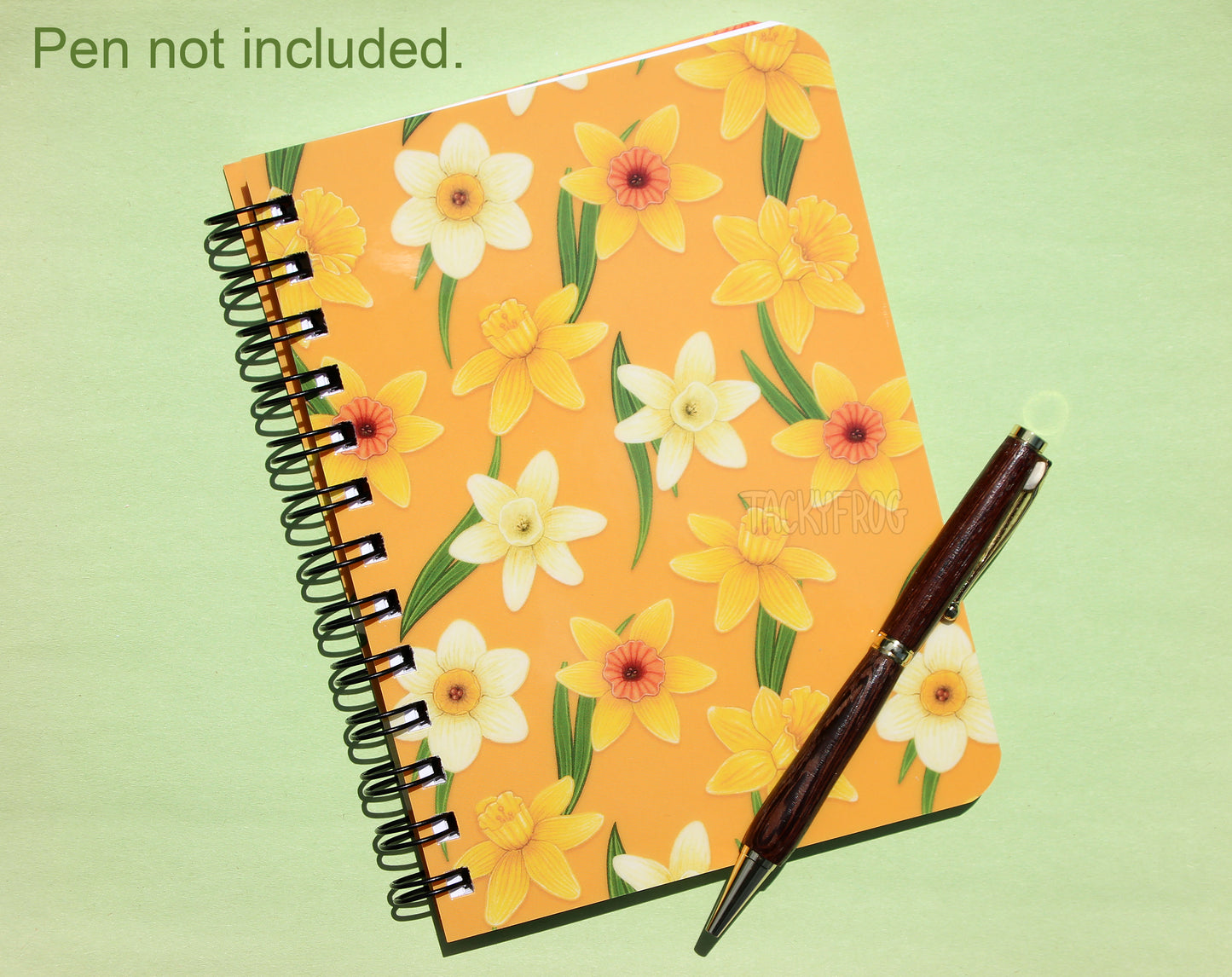 A yellow daffodils mini notebook. The text in the upper left corner reads "Pen not included".